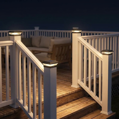 Deck corner at night lit by black solar post cap lights