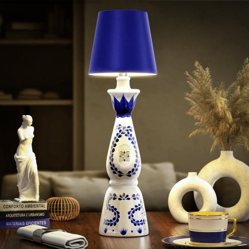 Hand-painted bottle lamp glowing warmly on a dinner table