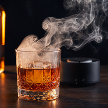 Wood smoke curling over a glass of whiskey