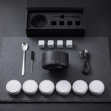 Everything in the kit: smoker, six flavour tins, chilling stones, spoon, brush, USB-C cable and gift box