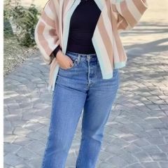 Apricot-toned cardigan worn over a black top outdoors