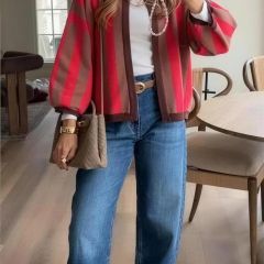 Red cardigan styled with jeans indoors