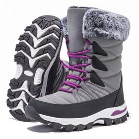 A pair of the boots, one tipped to show the full outsole tread pattern