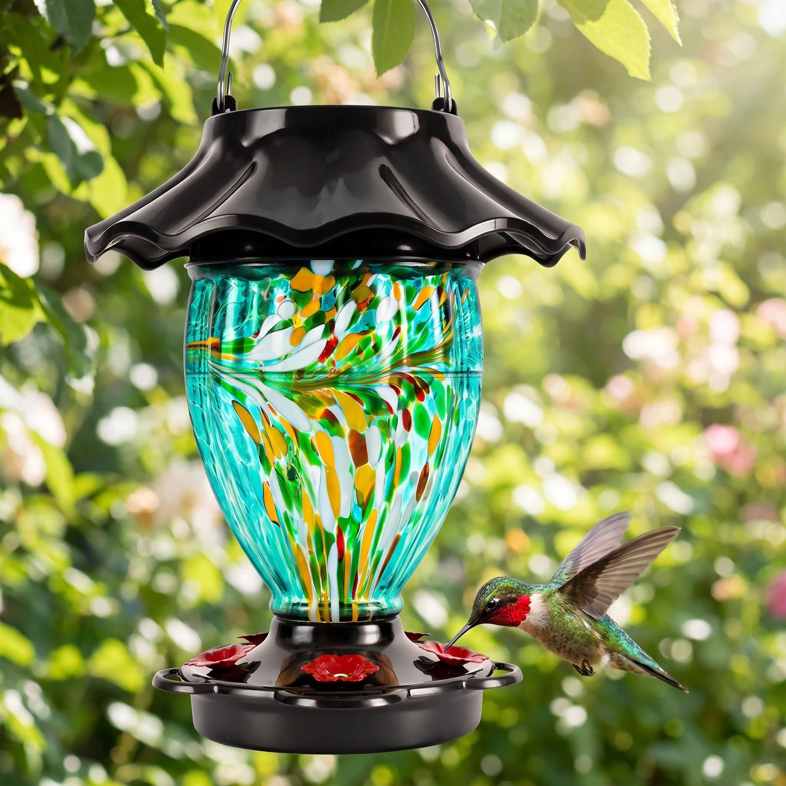 Hummingbird feeding at the red blossom ports of the glass feeder