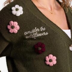 Close-up of the raised crochet flowers and the embroidered script