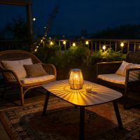 Rattan lantern on a rooftop patio table at dusk