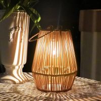 Single rattan lantern glowing on a table