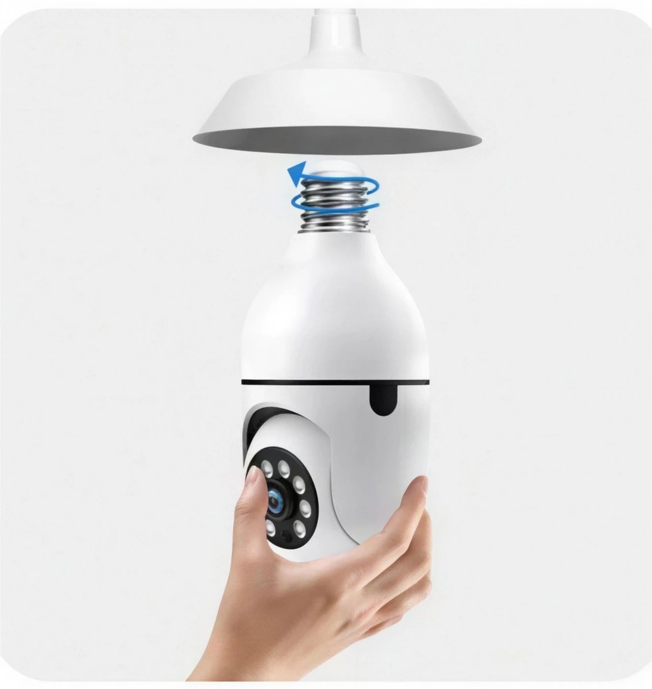 A hand screwing the bulb camera into a ceiling light fixture