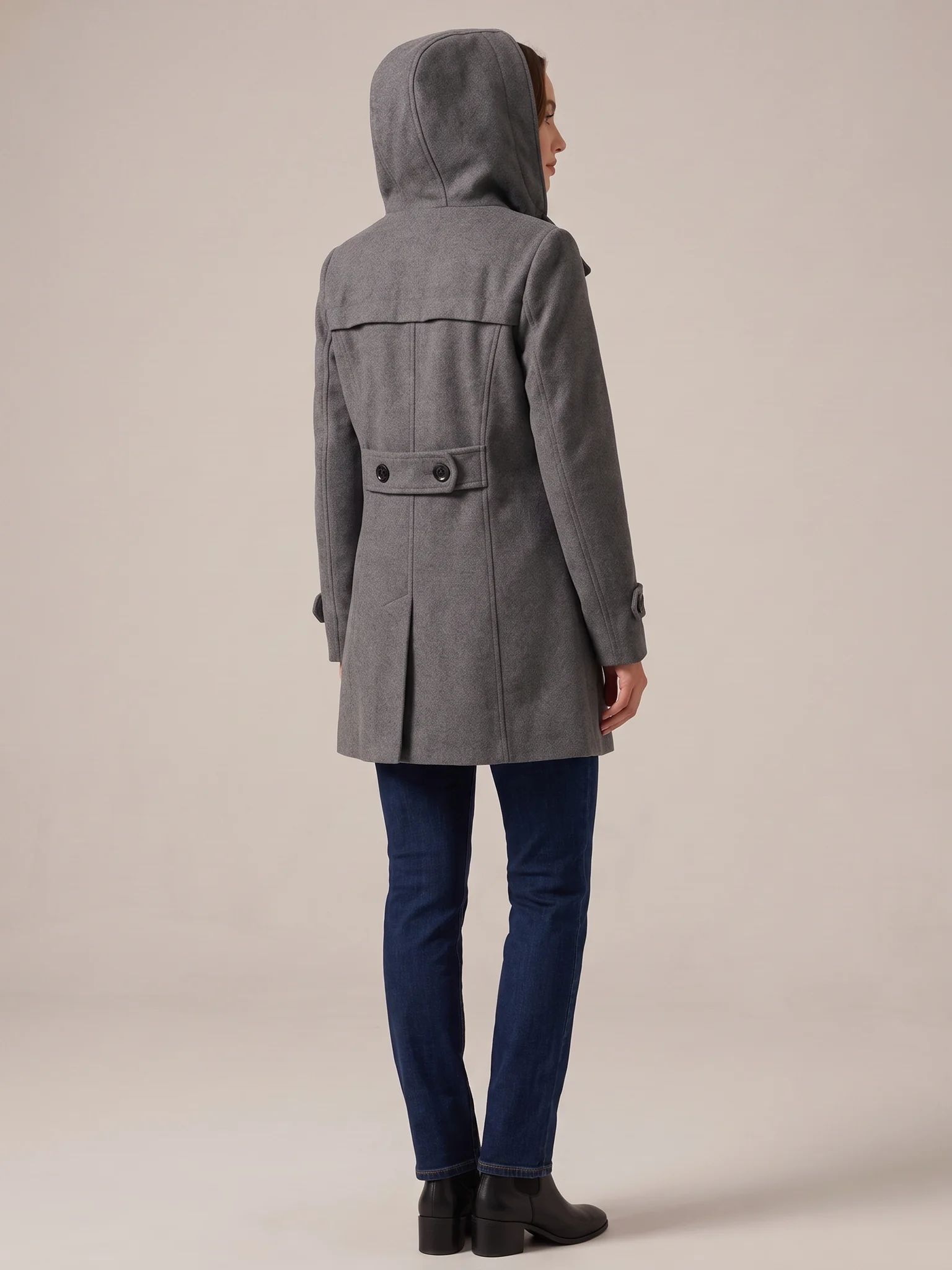 Back of the Charcoal hooded wool pea coat with the hood up, showing the buttoned waist tab and back vent