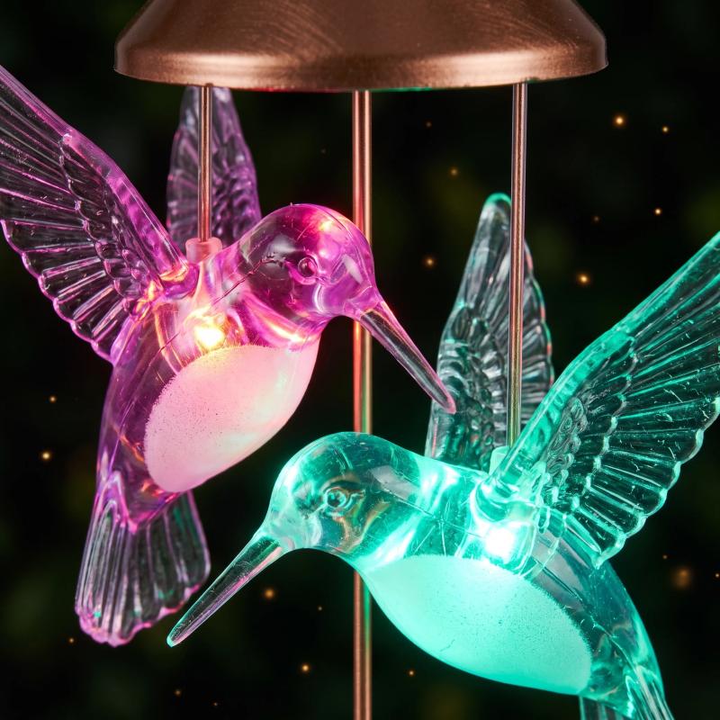 Macro view of two glowing hummingbirds, one magenta and one cyan